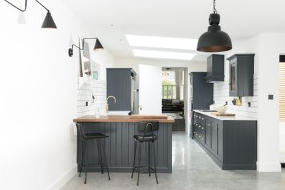 Extending for under £50,000: small black scheme kitchen in island with breakfast bar