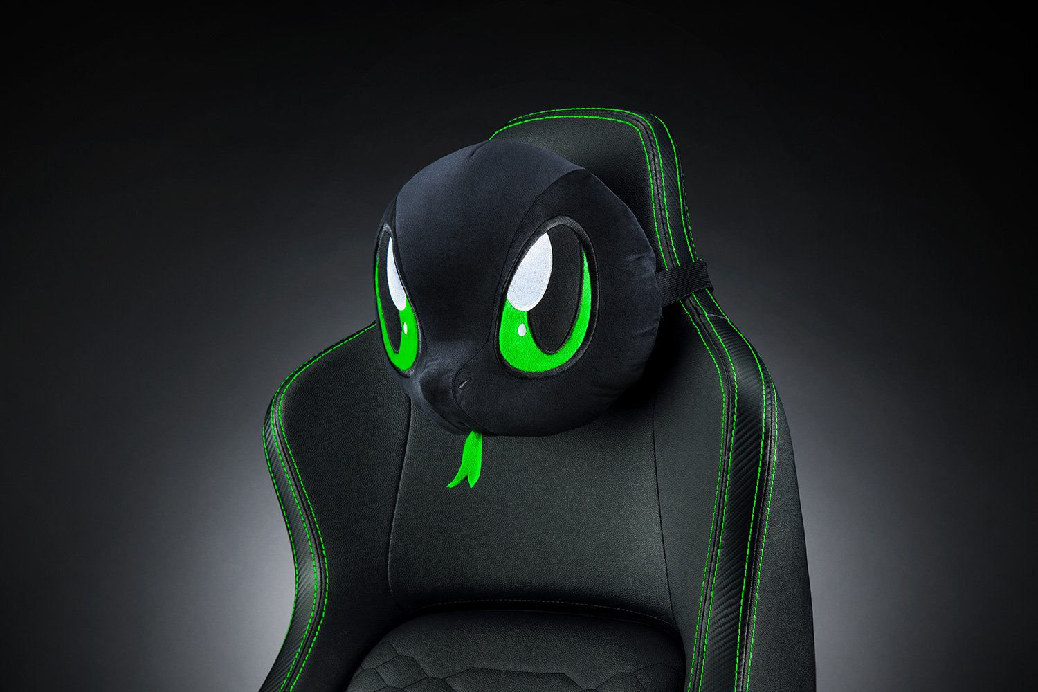 Bantal Kepala Razer Sneki Snek di kursi permainan dengan latar belakang hitam