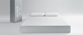 The Ergoflex 5G mattress in a plain white room next to the delivery box