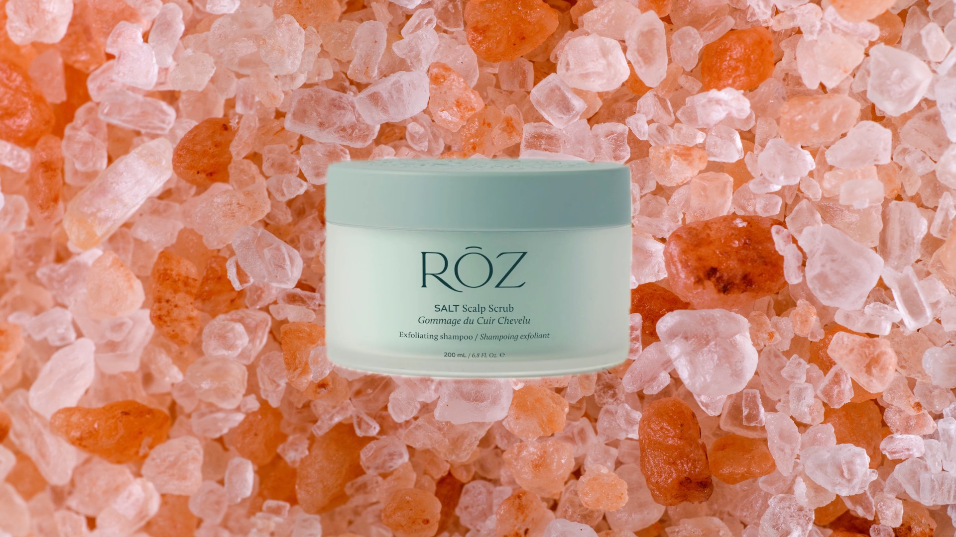 a jar of scalp scrub edited on top of himalayan salt crystals