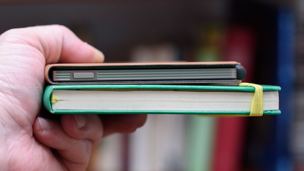 reMarkable Paper Pro Move tablet in front of a library of books, showing various writing screens and comparing the size to a Moleskine notebook