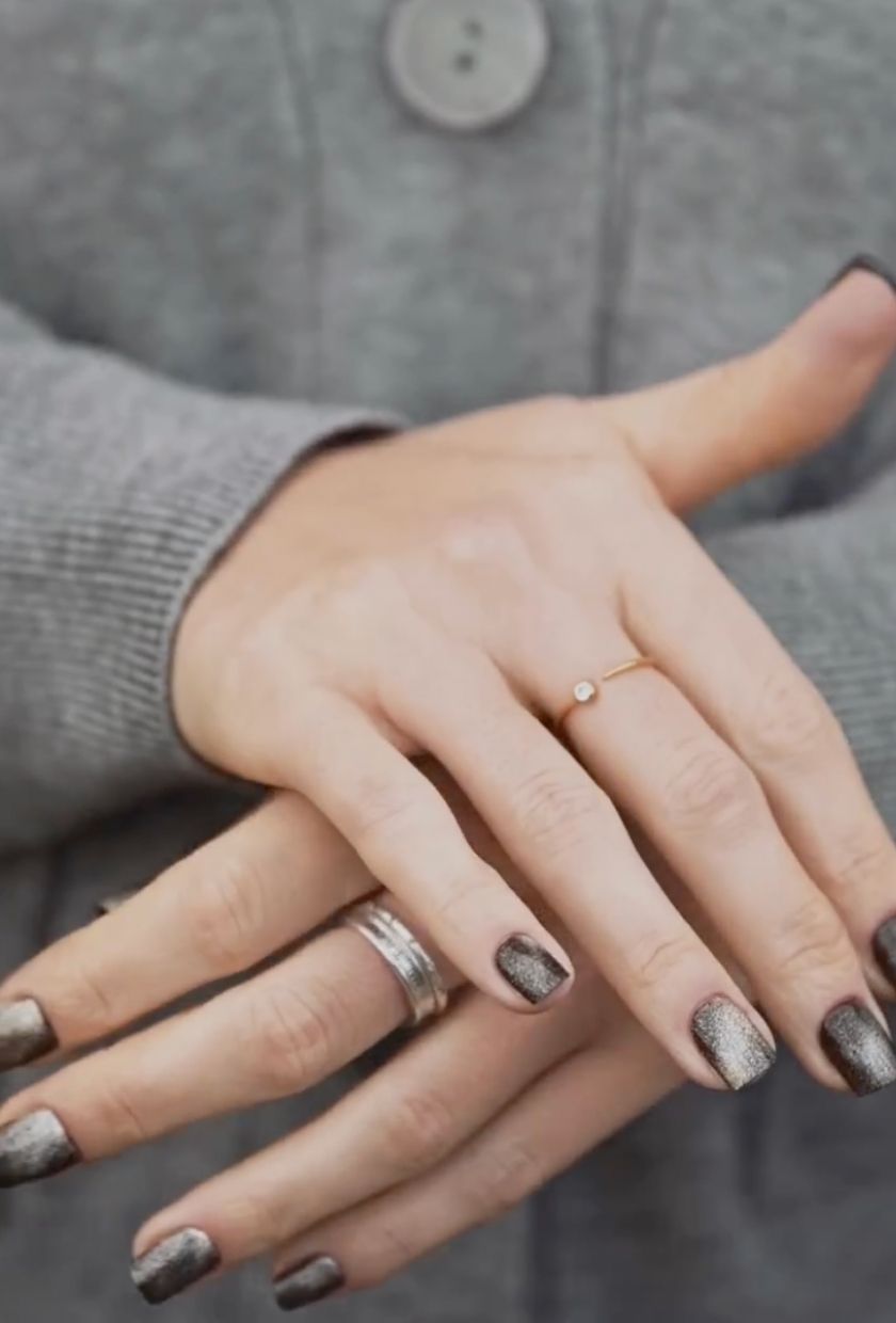 a close-up shot of charcoal grey velvet nails