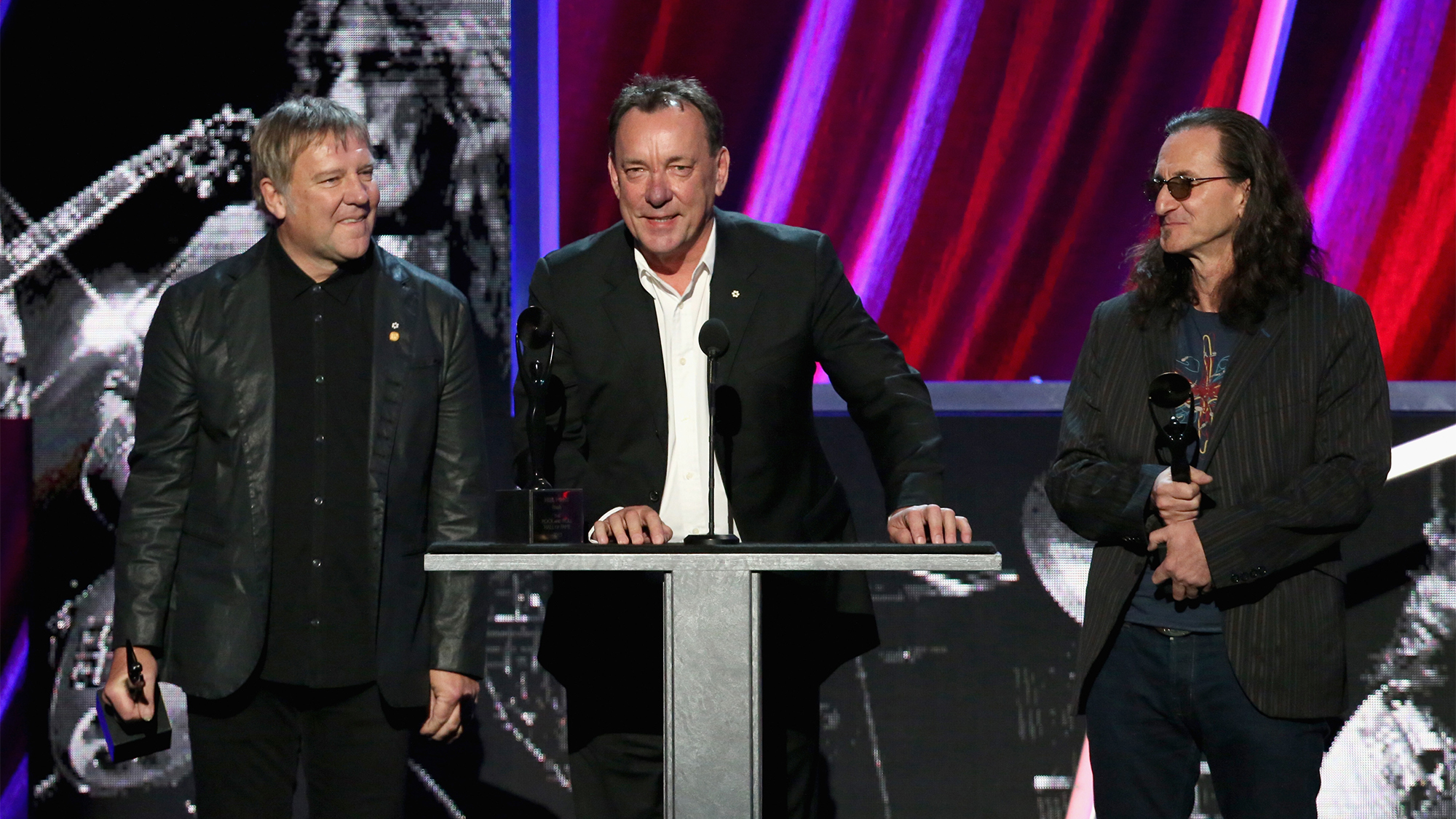 (from left) Alex Lifeson, Neil Peart and Geddy Lee of Rush onstage during the 28th Annual Rock and Roll Hall of Fame Induction Ceremony at Nokia Theatre L.A. Live on April 18, 2013 in Los Angeles, California.