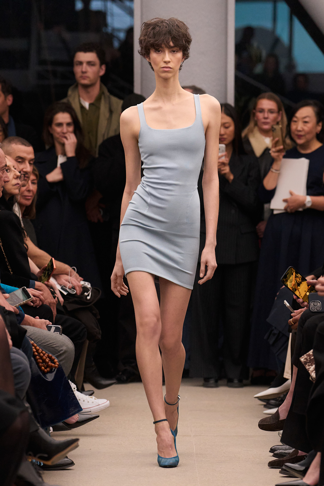A model at the Alaia show wearing blue shoes.