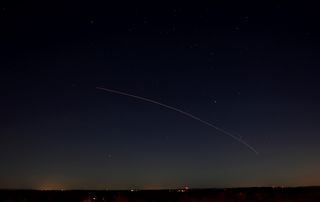 Skywatcher Debbie Stone captured this photo of a Minotaur 1 rocket streaking across the night sky as seen from Charlton, Mass., on Nov. 19, 2013. The rocket launched 29 small satellites into orbit from NASA's Wallops Flight Facility on Wallops Island, Va.