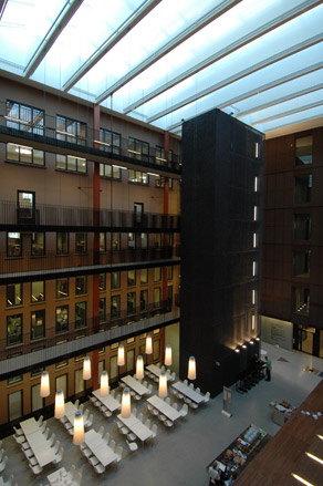 Looking down towards the ground floor of a library with tables and seating
