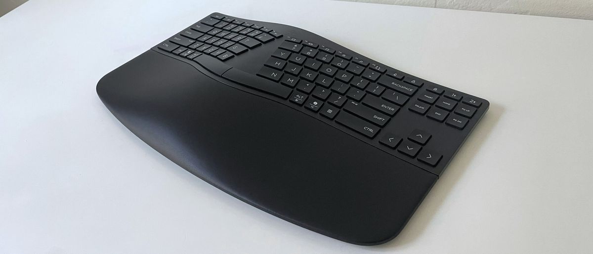 The HP 960 Ergonomic Keyboard on a white desk