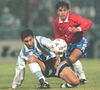 Argentina's Leonardo Astrada and Chile's Esteban Valencia compete for the ball in a Copa America match in 1995.