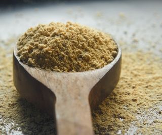 Cinnamon powder on a wooden spoon
