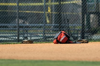 Baseball gear left on field at scene of shooting.