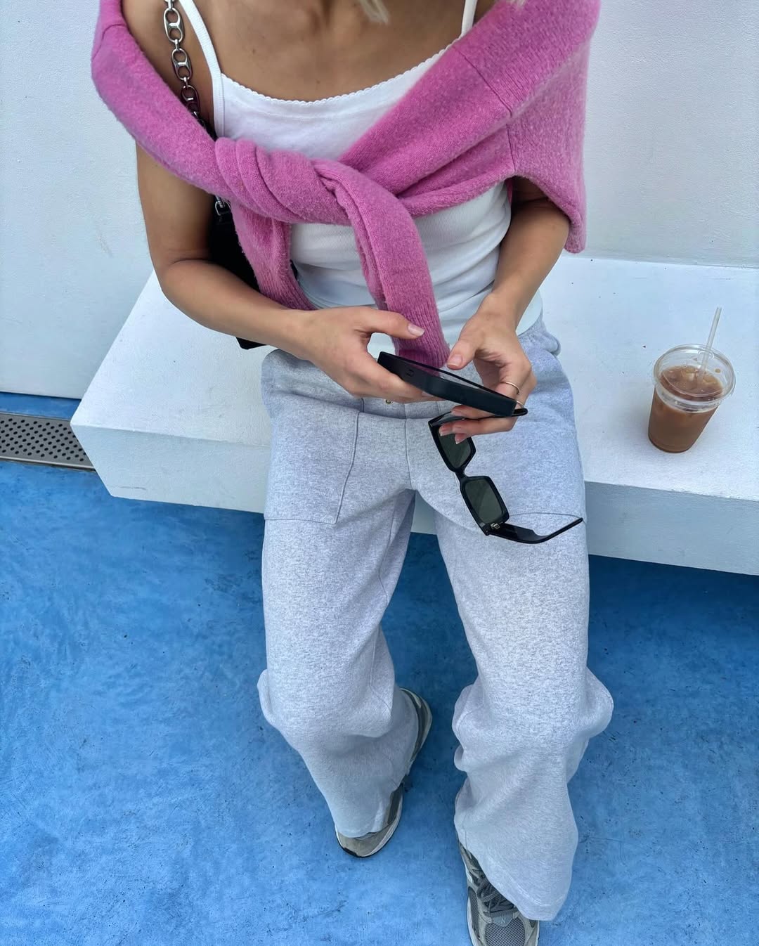Woman wearing a sweater styling idea for 2025 in summer.
