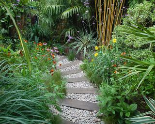 path with pebbles winding through planted borders