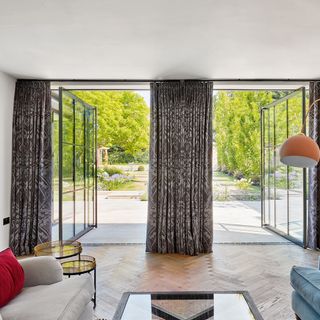 two large open pivot doors looking outwards from a living room