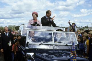 Queen Elizabeth ll and Prince Philip, Duke of Edinburgh wave to wellwishers in New Zealand