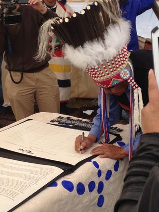 Chief Earl Old Person of the Blackfeet Tribe signs the buffalo treaty near Browning, Montana, on Sept. 23, 2014.