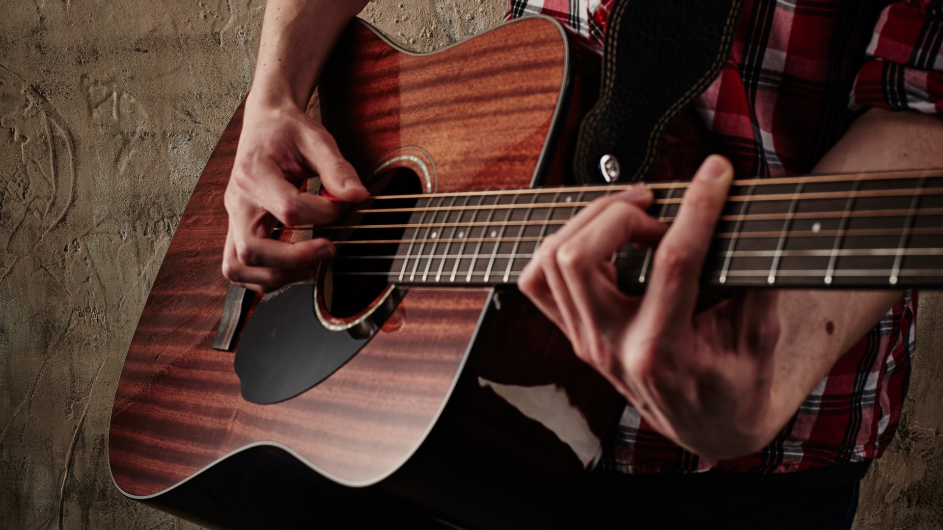 A man plays a Fender CD-60S All-Mahogany acoustic guitar