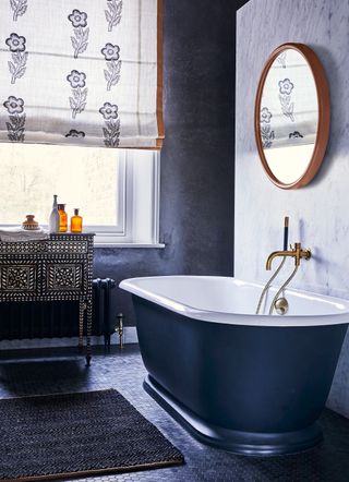 Introduce pattern to a black and white bathroom with a fabric blind
