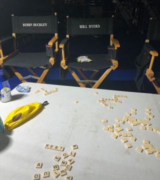 Robin and Will's actor chairs behind a table with Bananagram tiles spilled out