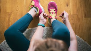 Woman tying up laces on trainers