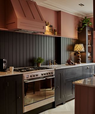 Dark grey kitchen with rust-coral upper cabinets