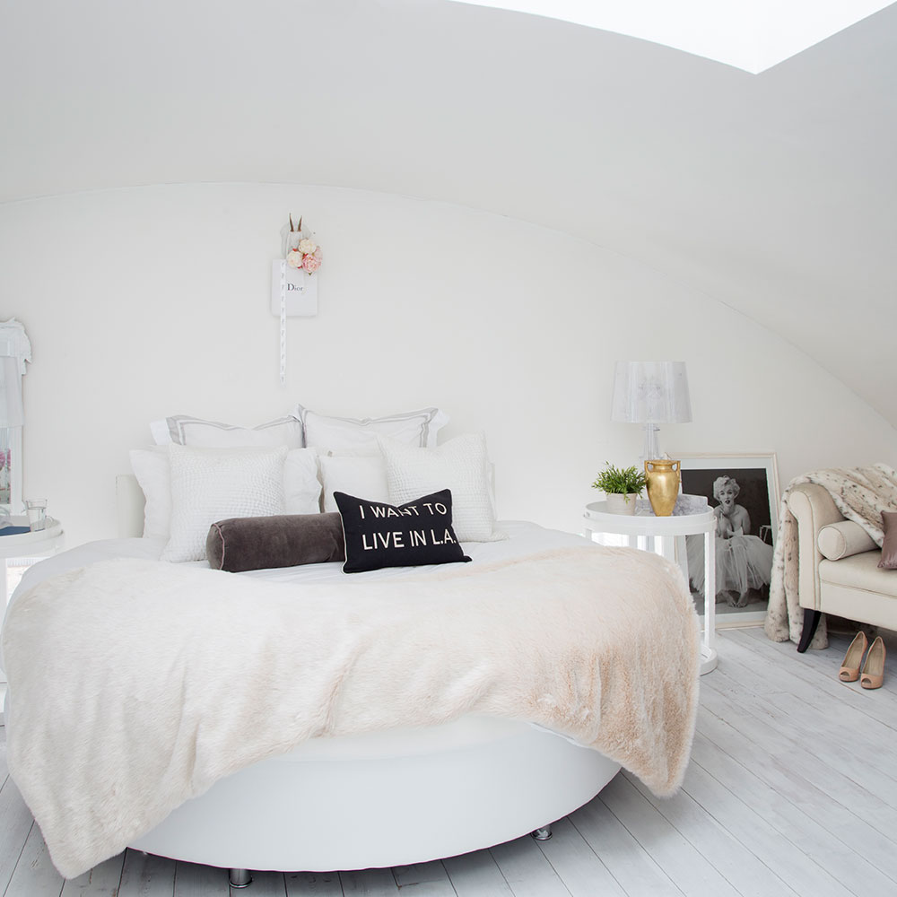 main bedroom with bed throw and cushions