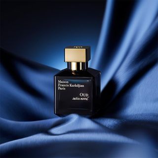 Maison Francis Kurkdijan Oud Satin Mood perfume bottle on a blue satin background