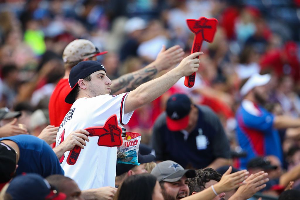 Atlanta Braves fans do the Tomahawk Chop.