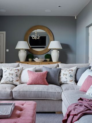 colors mixed and matched on pillows on a sofa in a grey living room