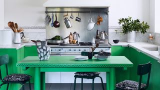 green and white kitchen with industrial steel range cooker showing a vibrant paint color ideas for a kitchen