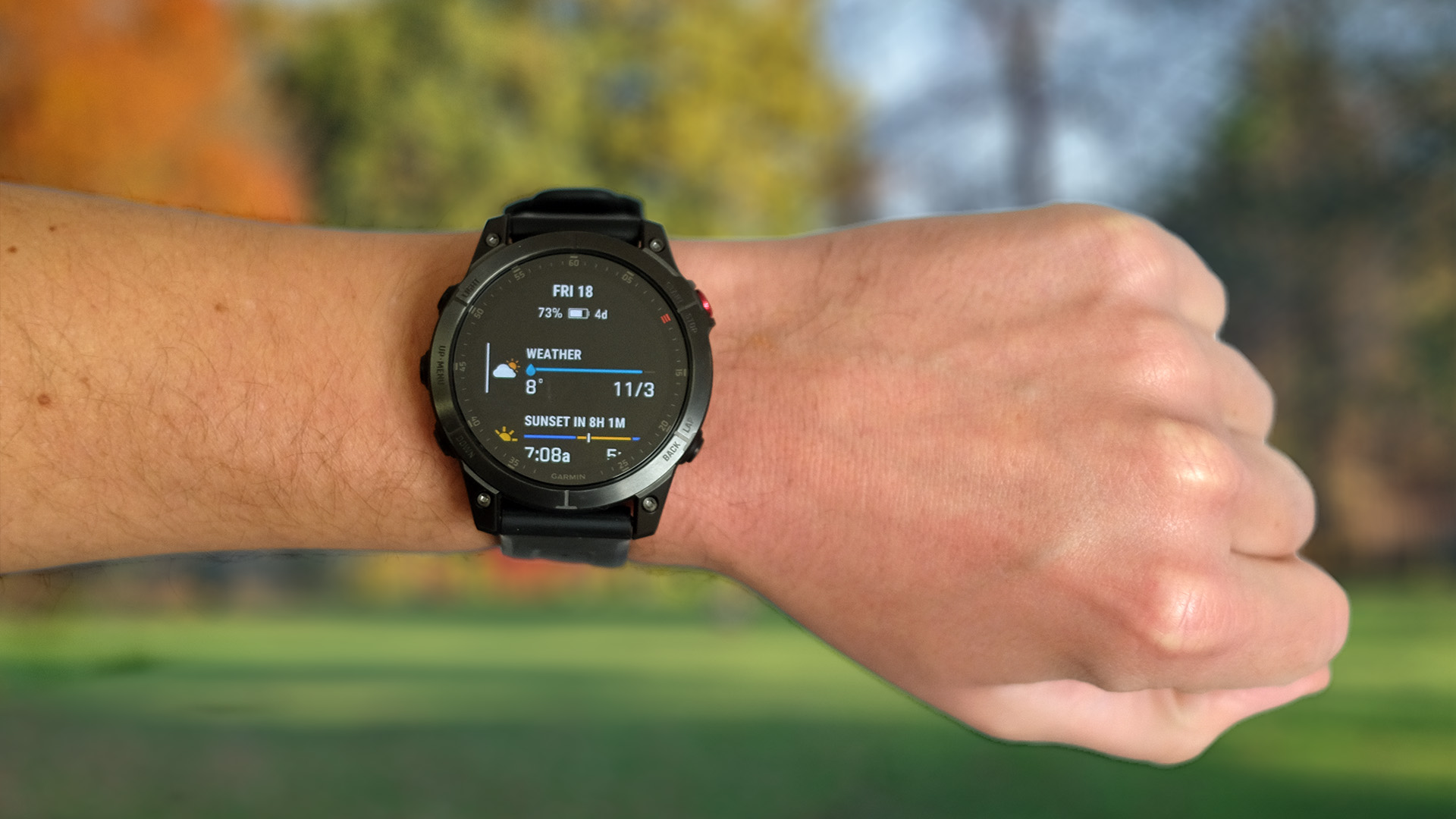Garmin Epix 2 worn on the person's wrist displays the weather on the watch face