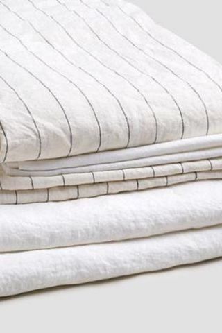 Linen stripe bedding set from Piglet in Bed stacked in a pile