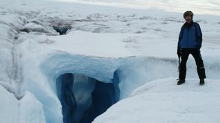 Climate scientist Konrad Steffen stands on the ice in Greenland in 2008.