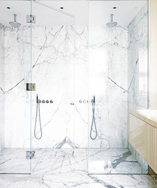 Luxury bathroom with marble surround and dual shower heads