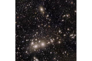 An image of lots of stars and galaxies in space.