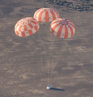 A test version of NASA’s Orion spacecraft touches down in the Arizona desert after its most complicated parachute test to date.