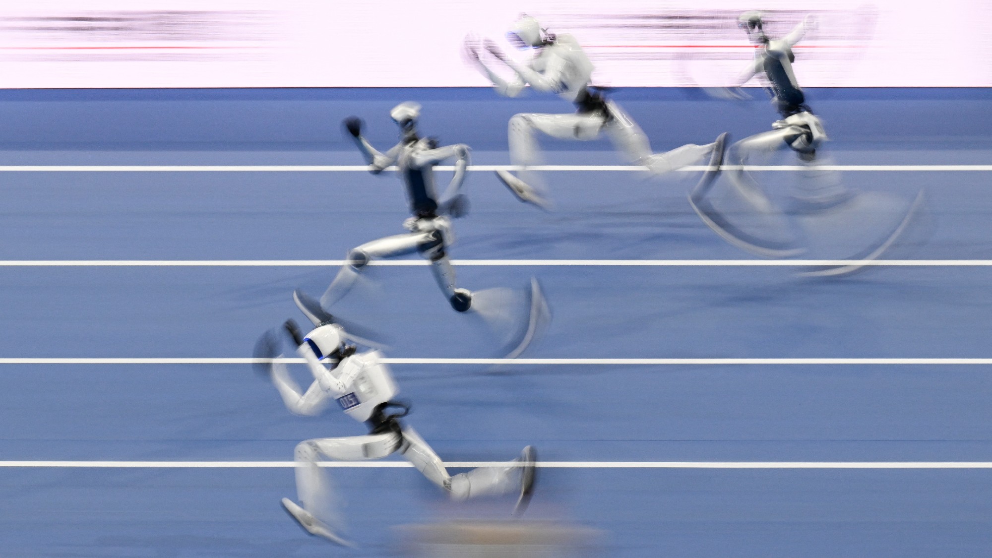 Humanoid robots compete in the 100-meter race during the second World Humanoid Robot Games in Beijing, China