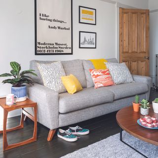 Mid century living room with grey sofa and dark wood side table