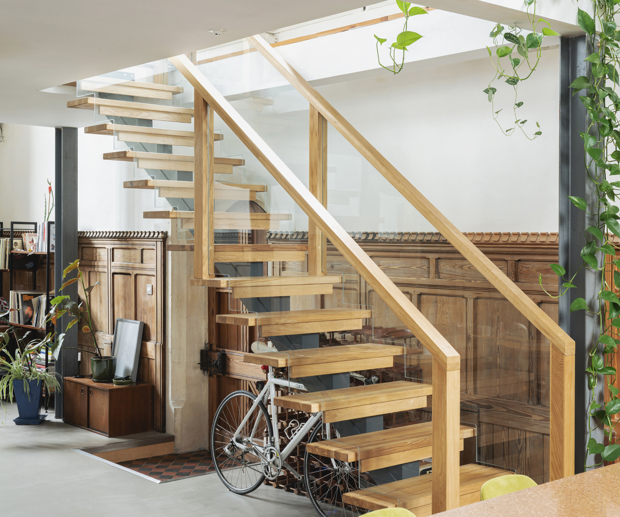 Wooden ghost staircase with wooden panelling behind it and white walls