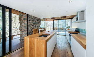 wooden worktops exposed stone wall kitchen