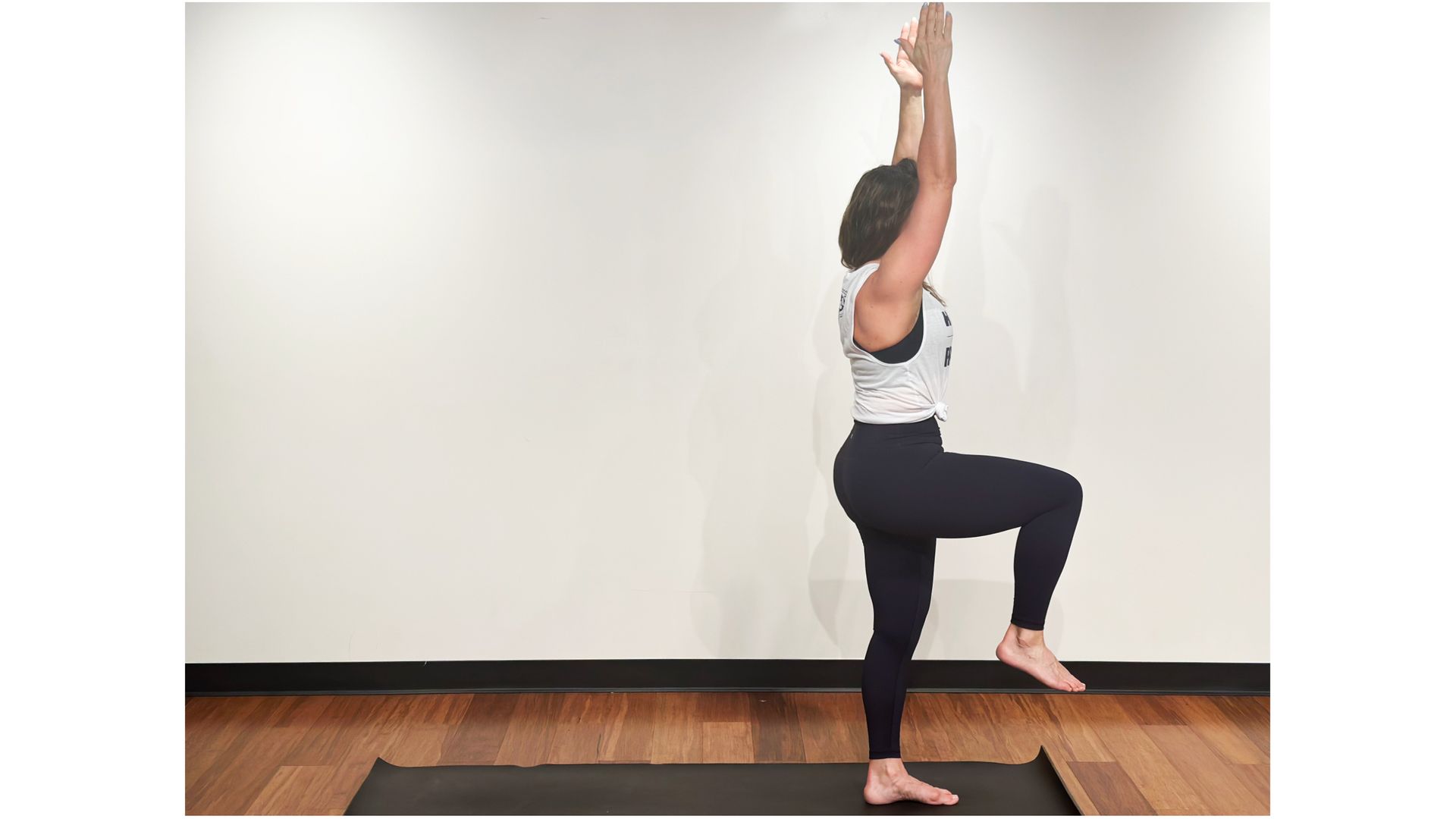 Wendy Cope holding a knee raise balance