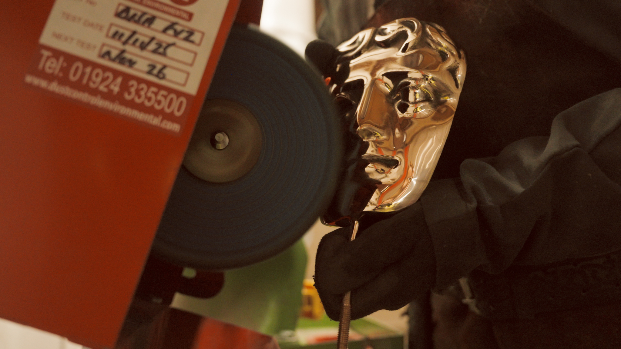 A Bafta is polished by a machine