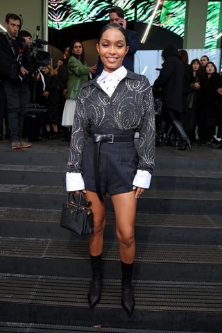 Yara Shahidi wearing an embellished grey top and tailored shorts and pointed toe heels