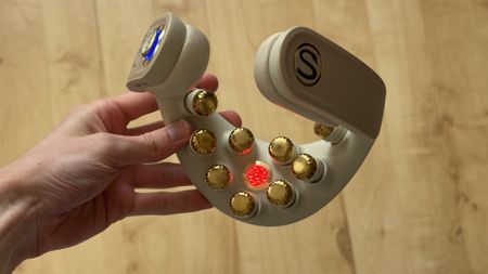 The SKG G7 Pro Fold neck massager being held in the hand