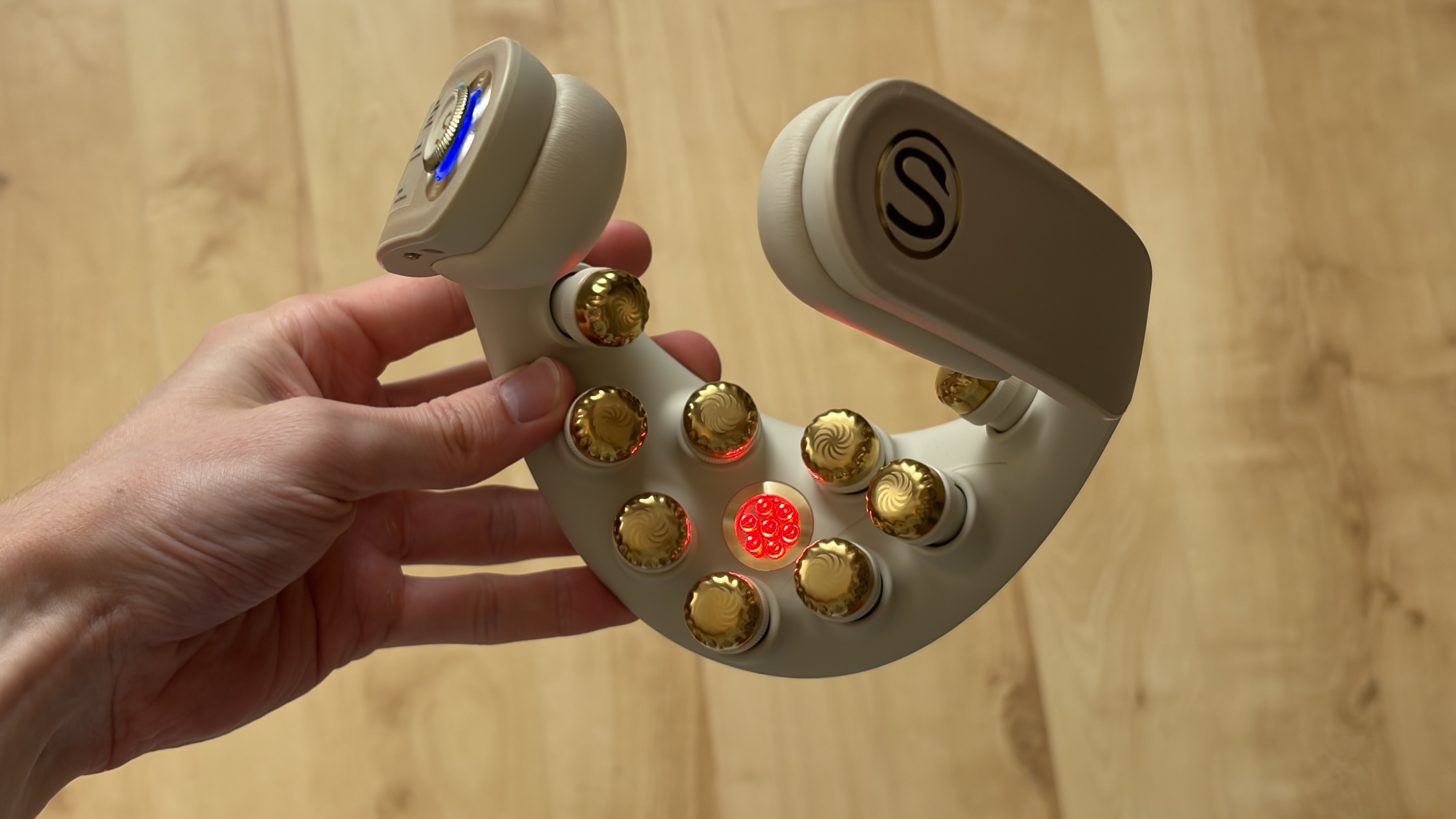 The SKG G7 Pro Fold neck massager being held in the hand