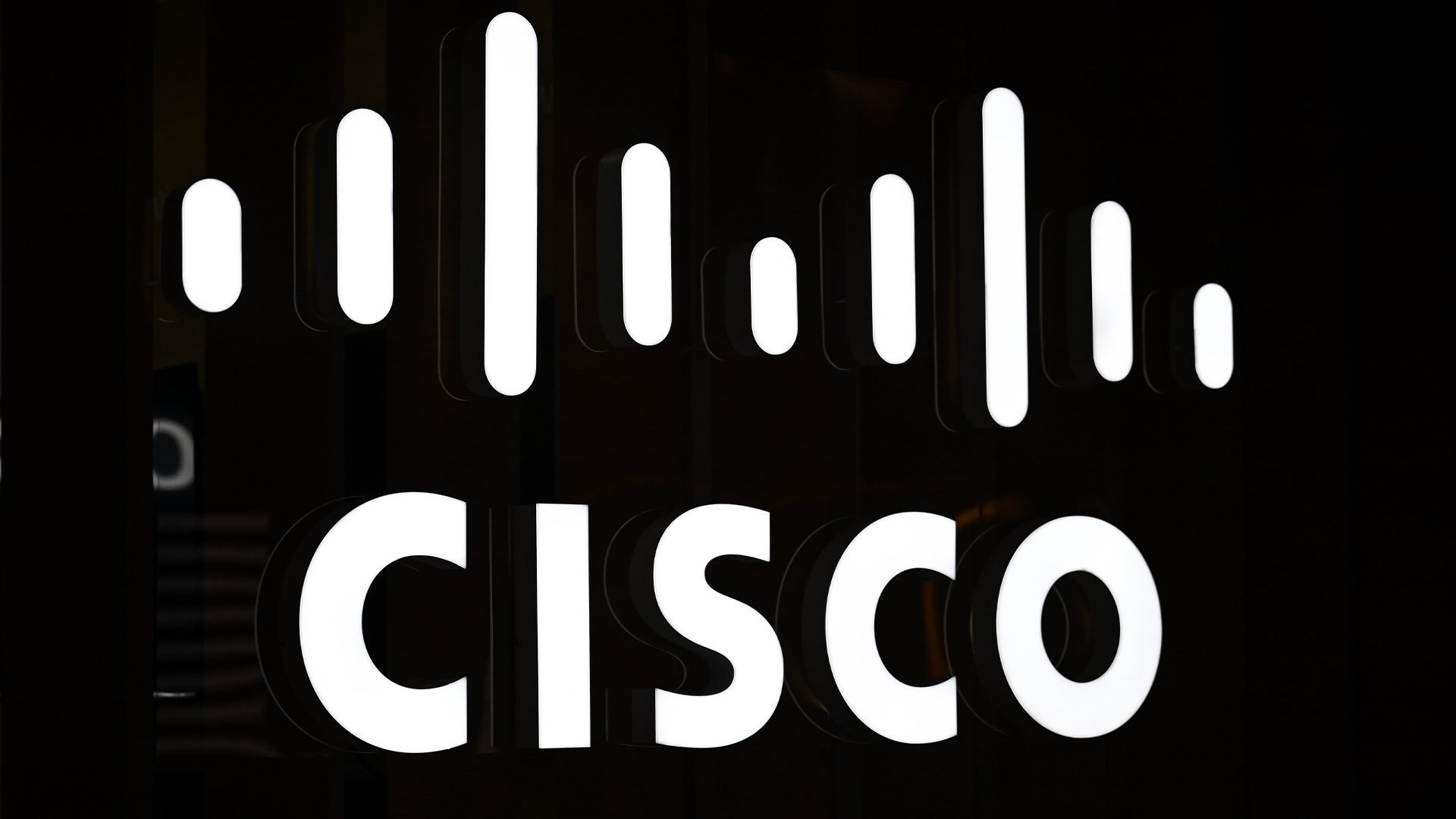 Cisco logo and branding illuminated in white against a black backdrop at Web Summit Qatar 2024.