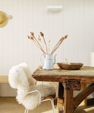 rustic dining table with chair and sheepskin