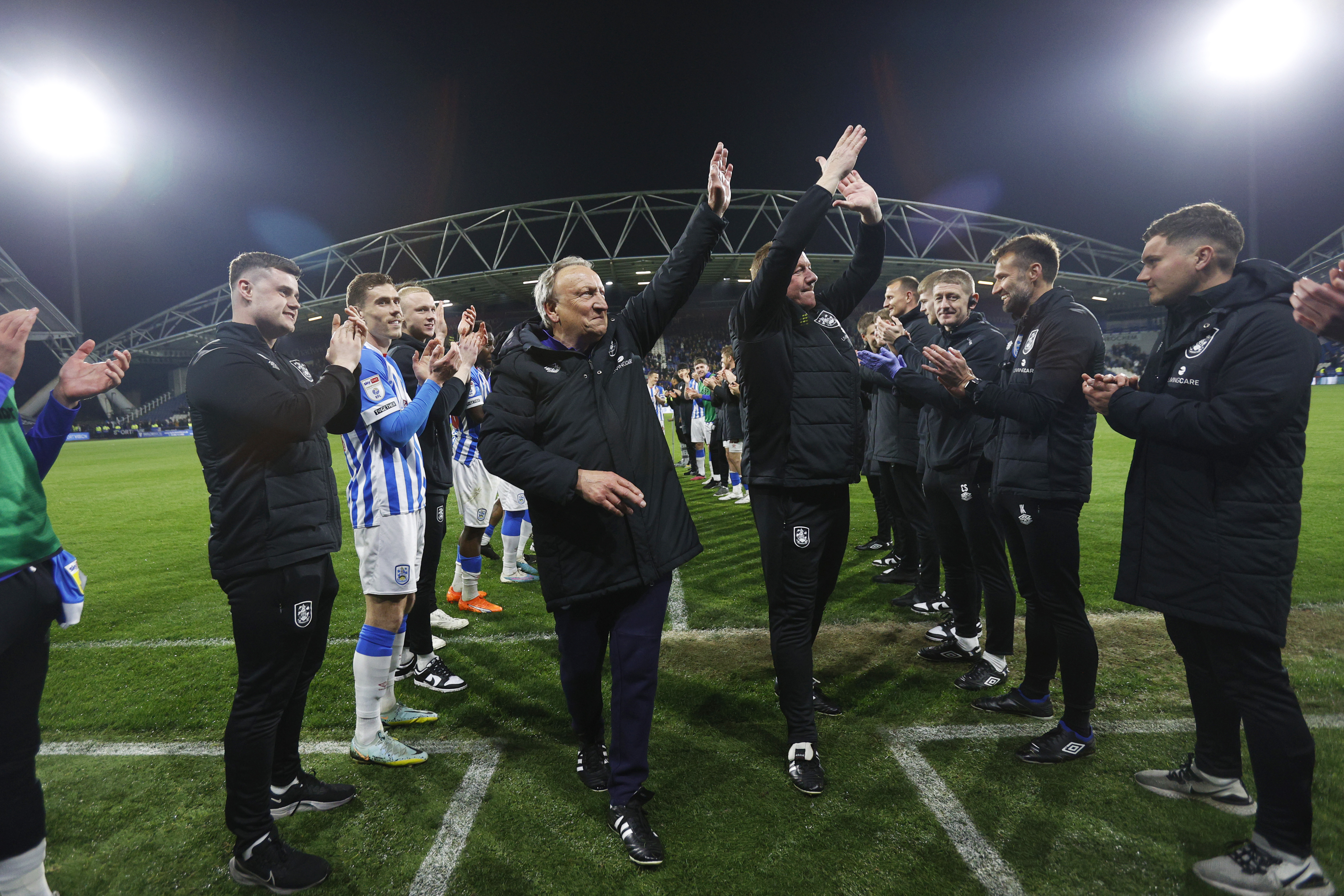 Neil Warnock and assistant Ronnie Jepson are applauded off the pitch after Huddersfield Town secure safety from relegation in 2023