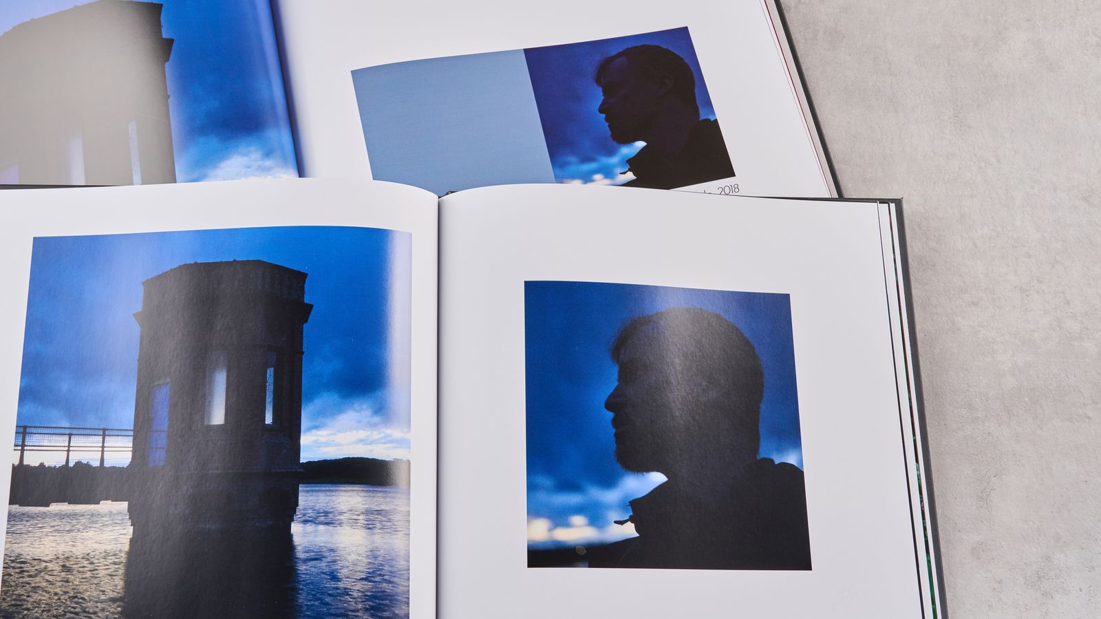Comparing twilight scenes in the Papier photo book at the front and the Blurb photo book at the back.