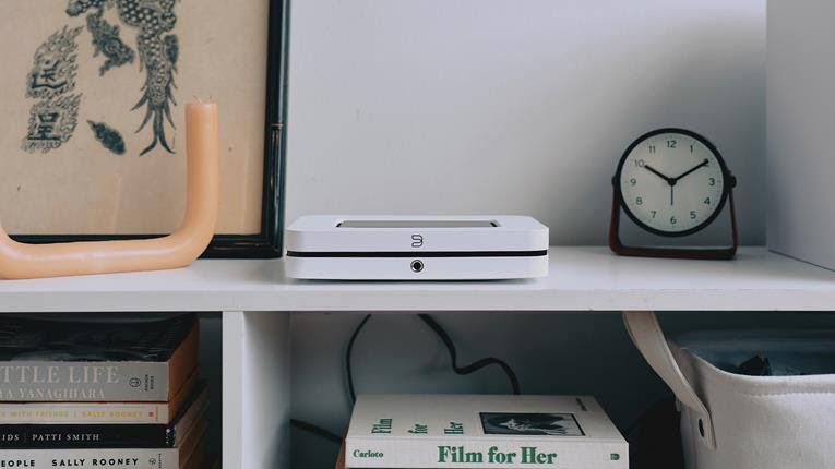 Bluesound Node in white on a shelf