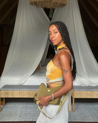 Amaka Hamelijnck wearing a breezy top on a tropical getaway